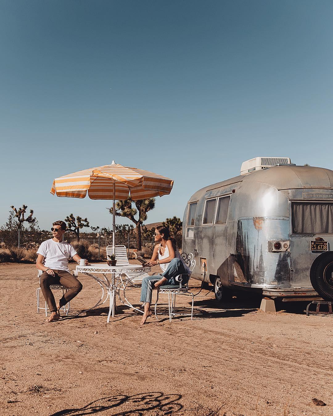 The meme is a humorous image of a couple sitting at a table in a desert, with a trailer (a type of RV) in the background. The text on the image reads "When you finally get the Wi-Fi password from your neighbor". The image is likely meant to be humorous because it pokes fun at the common frustration of trying to get internet access in rural or remote areas, and the excitement of finally achieving it.